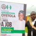 Man Erects Roll-up Banner At Osun Secretariat To Beg Governor Oyetola For Job (Photos)