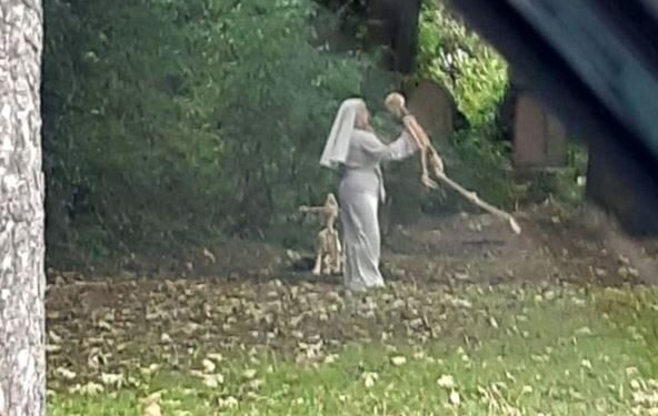 Shock As Woman Who Is Dressed As A Nun Is Seen Dancing With Skeletons In Graveyard (Photos)