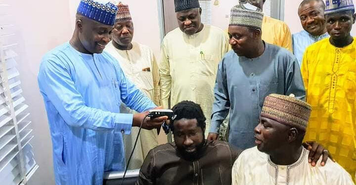 PDP Member Who Vowed To Never Have A Hair Cut Until Buhari Resigns Gets His Hair Shaved After Decamping To APC (Photos)