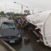 Tanker Falls At Costain, Crushes Car And Spills Its Content On The Road (Video)