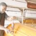 Meet Olushoto, The Nigerian Computer Graduate Who Turned Into A Coffin Maker