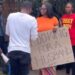 Beautiful Lady Carries Placard On Road With Inscription “Looking For A Husband” (Video)