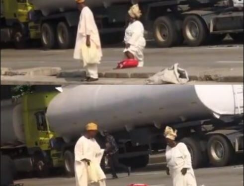 See The Heartwarming Moment A Patient Elderly Man Helped His “Stubborn” Wife To Climb A Road Divider (Video)