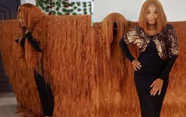 Nigerian Lady Makes History, Sets Guinness World Record For The Widest Wig (Video)