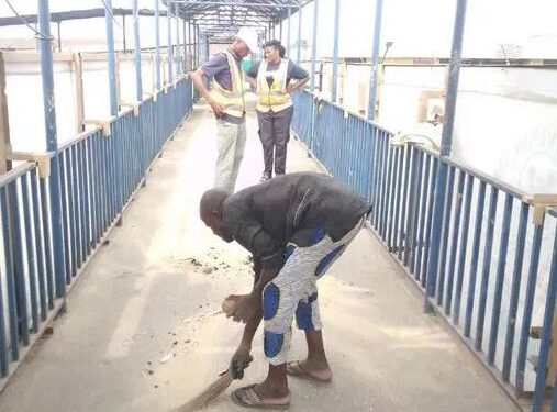Watch The Moment Lagos Hoodlums Forced To Sweep Pedestrian Bridge For Defecating On It (Video)