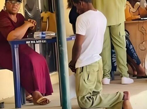 This Is What We Are Passing Through – Man Writes As He Shares Photo Of Corps Member Kneeling Before An Official