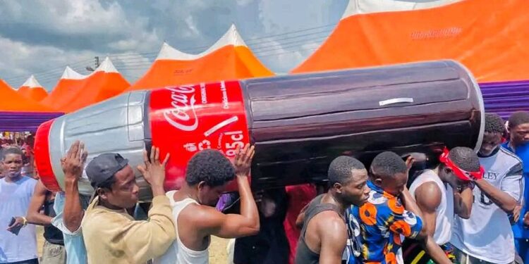 85-Year-Old Nigerian Woman, ‘Ego Na Money’ Gets Buried Inside A Coca-Cola Bottle-Shaped Casket In Bayelsa (Photos+Video)