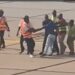 Drama At Airport As Man Attempts To Sneak Between Aircraft Tyres To Escape To The U.S. (Video)